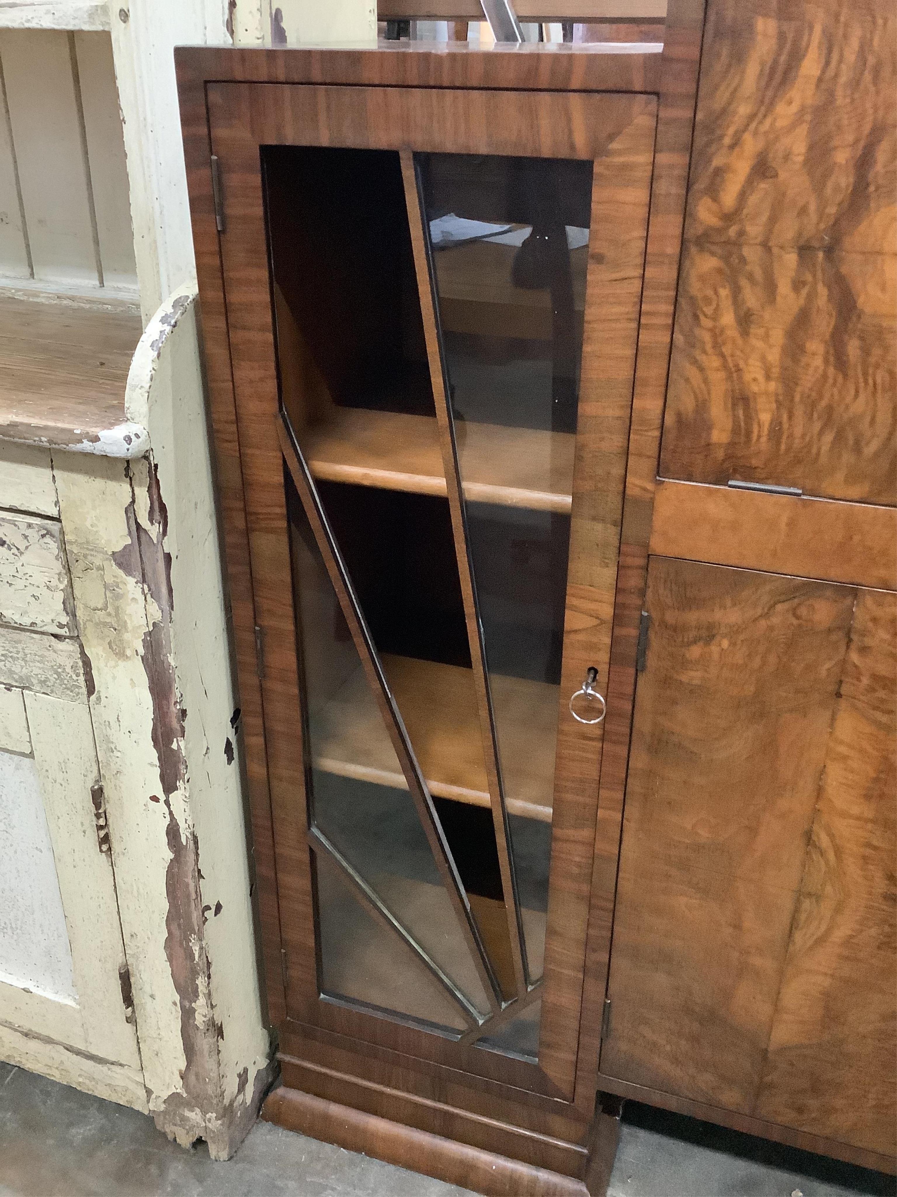 An Art Deco figured walnut cocktail cabinet, width 136cm, depth 39cm, height 123cm. Condition - one glass panel missing, otherwise fair